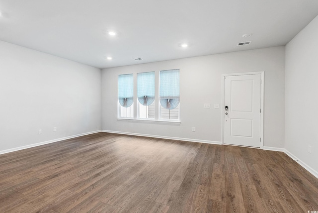 empty room with dark wood-type flooring