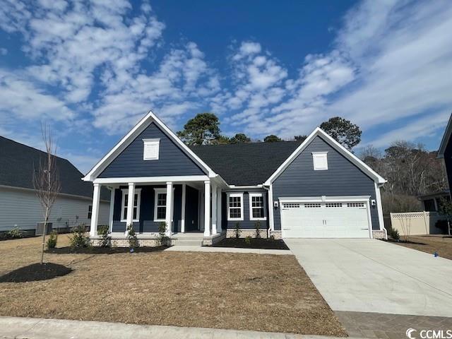 view of front of home featuring a front yard and a garage