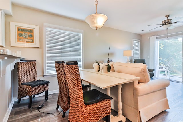 dining space with hardwood / wood-style flooring and ceiling fan