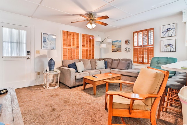 carpeted living room with ceiling fan