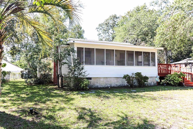 exterior space with a yard and a sunroom