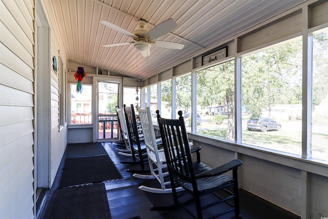 sunroom / solarium with ceiling fan, lofted ceiling, and a healthy amount of sunlight