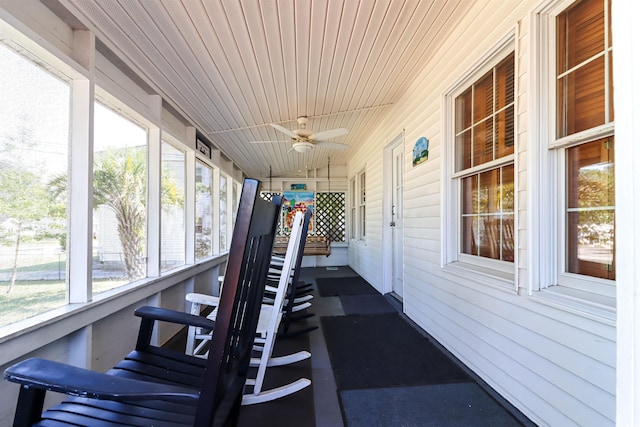 sunroom / solarium featuring ceiling fan and lofted ceiling