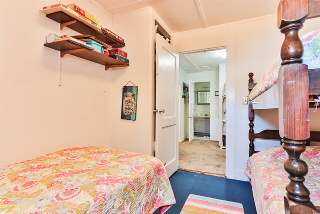 bedroom with crown molding and dark colored carpet