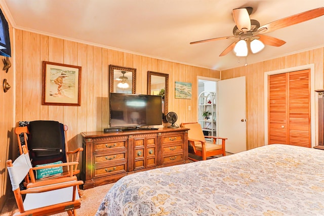 carpeted bedroom featuring ornamental molding, ceiling fan, wood walls, and a closet