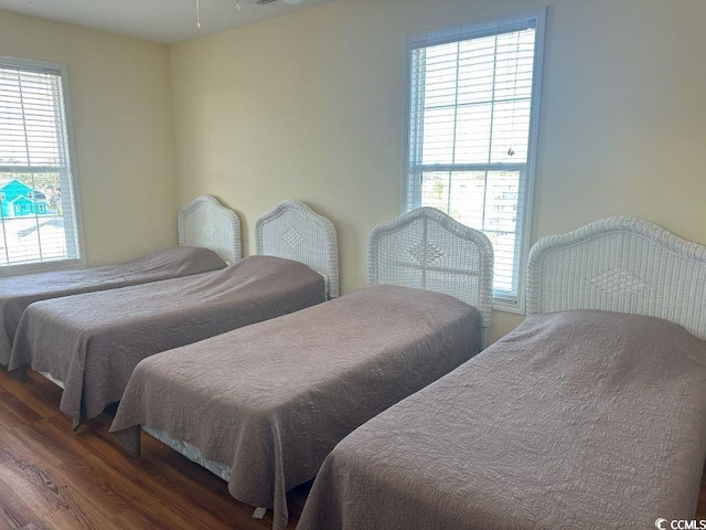 bedroom with dark hardwood / wood-style floors