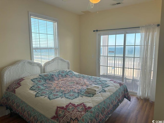 bedroom featuring multiple windows, ceiling fan, and hardwood / wood-style floors