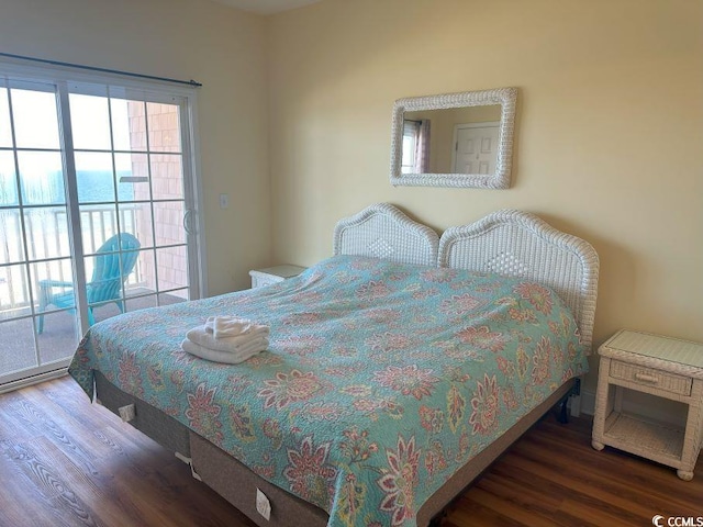 bedroom with access to outside and dark hardwood / wood-style flooring