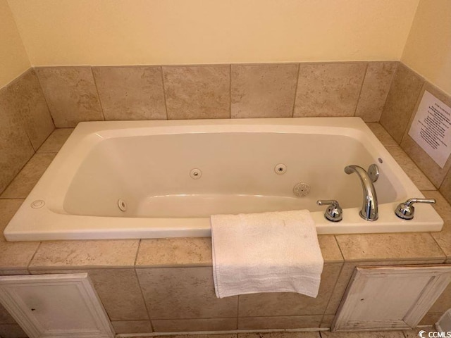 bathroom featuring tiled tub