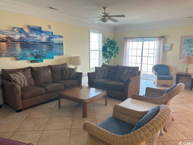 living room with light tile patterned flooring, crown molding, and ceiling fan