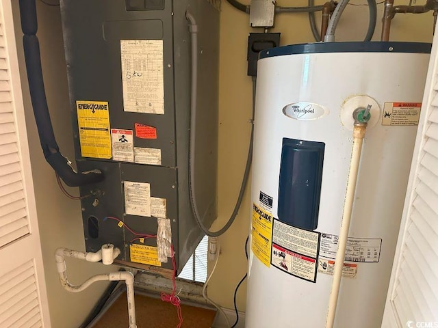 utility room featuring water heater and heating unit