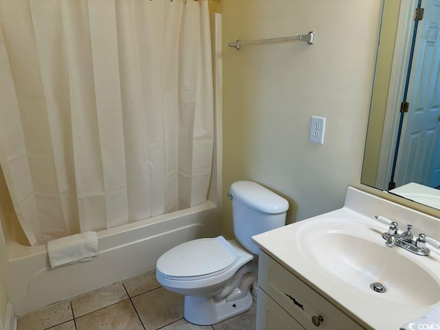 full bathroom featuring tile patterned flooring, shower / bath combo with shower curtain, vanity, and toilet