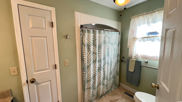 bathroom with walk in shower and toilet