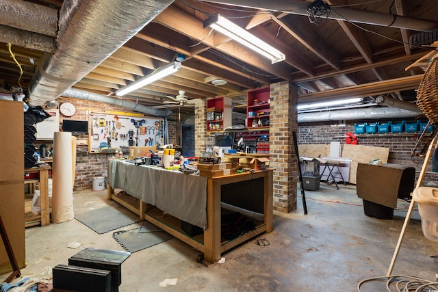 basement with a workshop area and brick wall