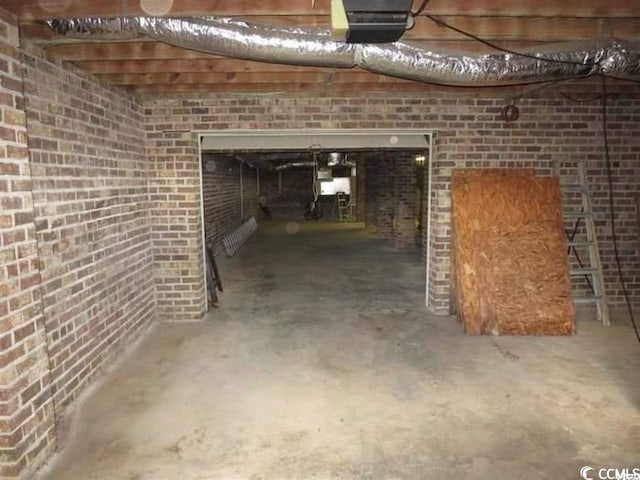 basement featuring brick wall