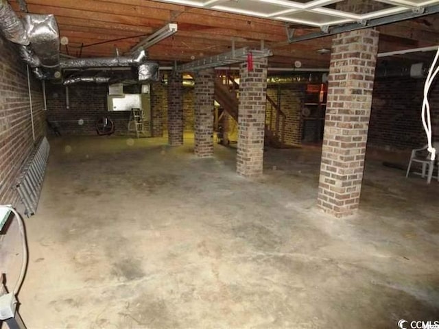 basement featuring brick wall