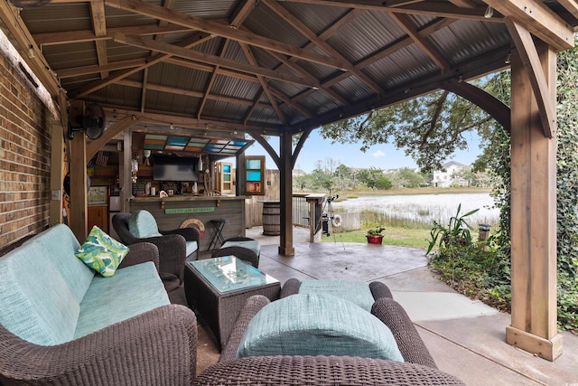 view of patio / terrace featuring a water view, an outdoor hangout area, and a gazebo