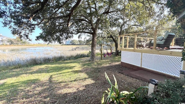 view of yard featuring a deck with water view