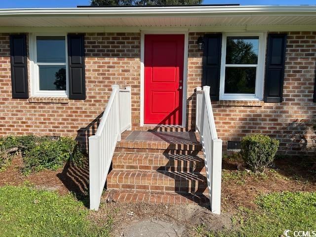 view of exterior entry featuring a porch