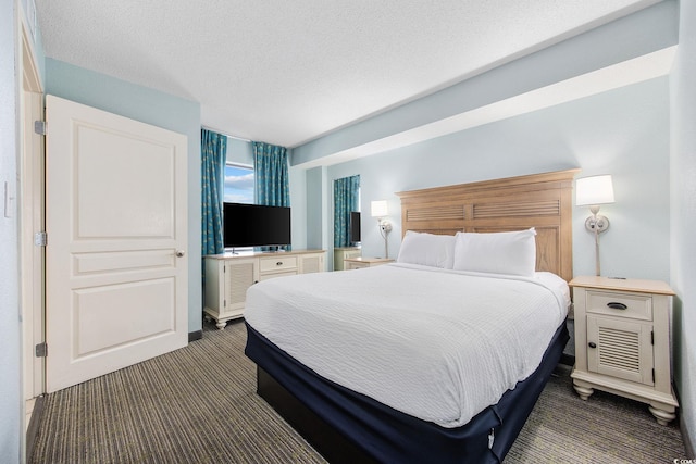 carpeted bedroom with a textured ceiling