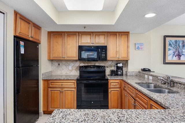 2301 Ocean Blvd S Unit 1218, Myrtle Beach, SC 29577 - kitchen featuring black appliances, a sink, light stone counters, and brown cabinetry