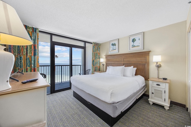 2301 Ocean Blvd S Unit 1218, Myrtle Beach, SC 29577 - carpeted bedroom with access to exterior, a textured ceiling, baseboards, and a water view