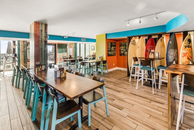 2301 Ocean Blvd S Unit 1218, Myrtle Beach, SC 29577 - dining space with rail lighting, wood finished floors, and baseboards