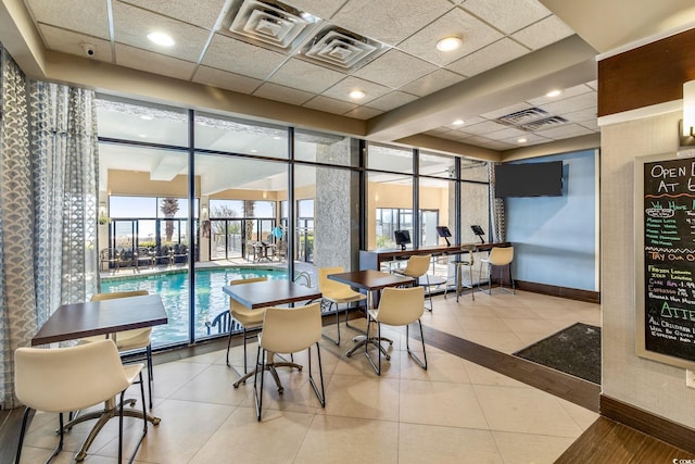 2301 Ocean Blvd S Unit 1218, Myrtle Beach, SC 29577 - dining space featuring baseboards, a paneled ceiling, and tile patterned flooring