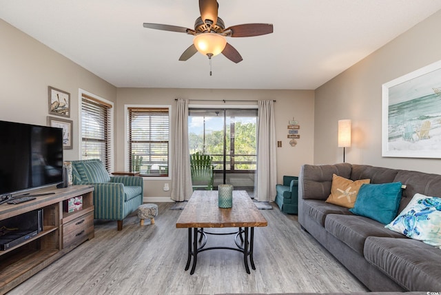 living room with light hardwood / wood-style floors and ceiling fan