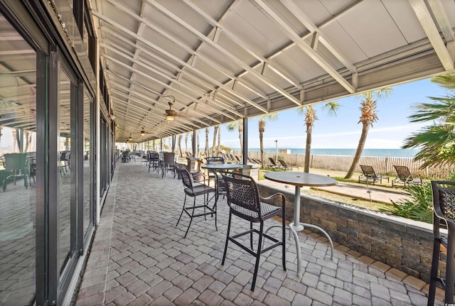 view of patio featuring a water view and a view of the beach