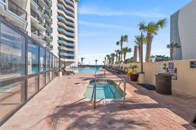 7100 N Ocean Blvd Unit 913, Myrtle Beach, SC 29572 - community pool featuring a community hot tub and a patio area