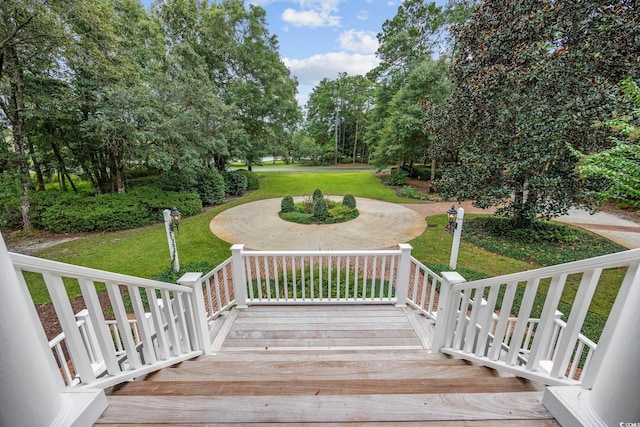 wooden deck featuring a yard