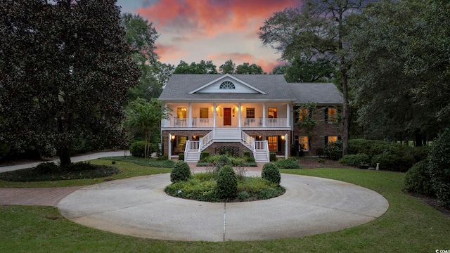 greek revival inspired property with a yard and covered porch