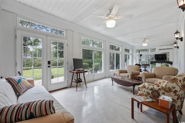 sunroom / solarium featuring finished concrete flooring and french doors
