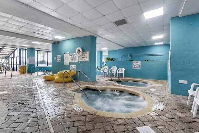 view of swimming pool featuring an in-ground hot tub