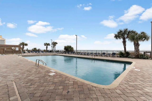 community pool featuring a patio area and fence