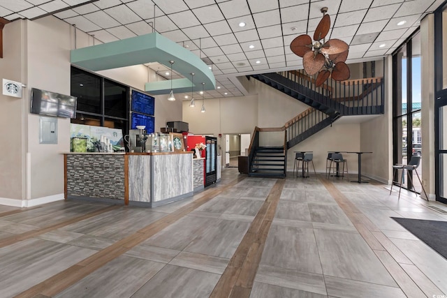 reception with a ceiling fan and stairway