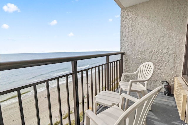 balcony with view of water and beach
