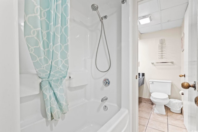 bathroom featuring tile patterned flooring, shower / bathtub combination with curtain, and toilet