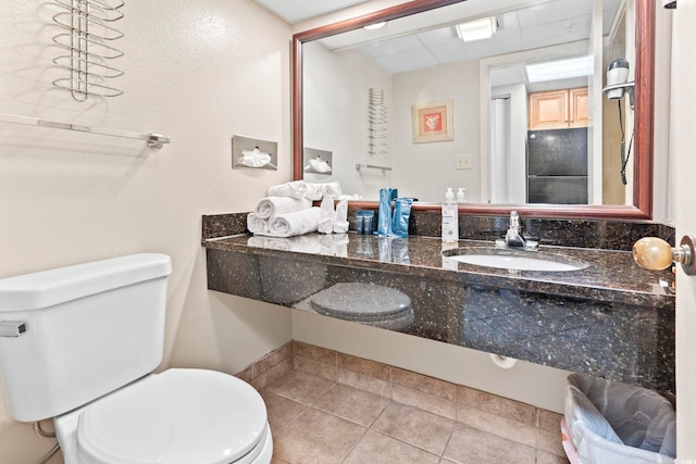 bathroom with tile patterned floors, vanity, and toilet