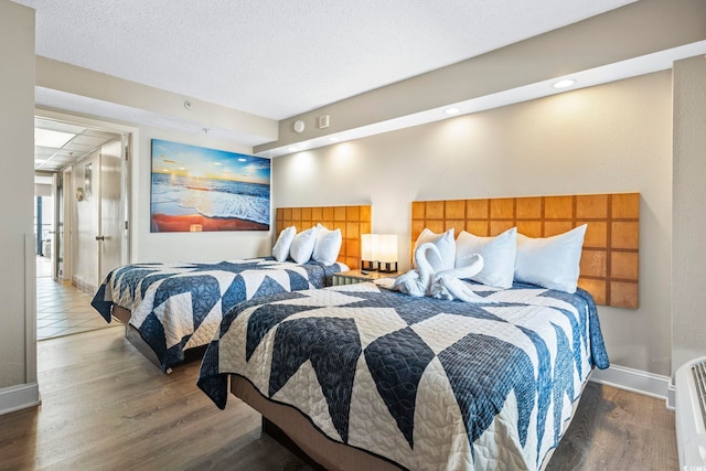 bedroom with wood finished floors and baseboards