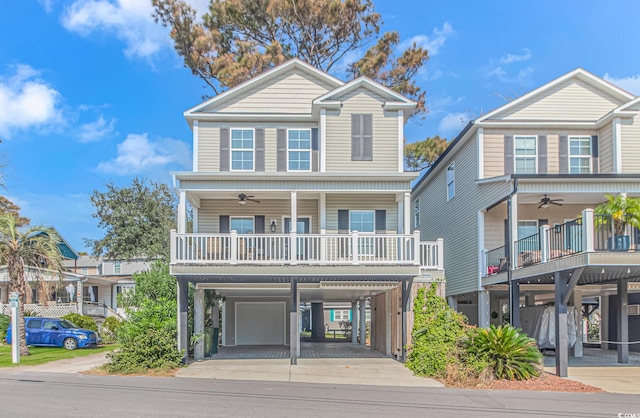 view of front of home featuring ceiling fan and a garage