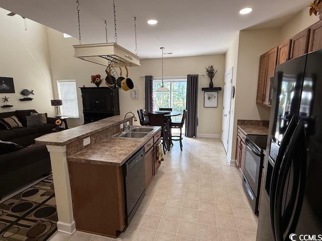 1188 Fairway Ln Unit 7, Conway, SC 29526 - kitchen with black appliances, recessed lighting, open floor plan, a center island with sink, and dark countertops