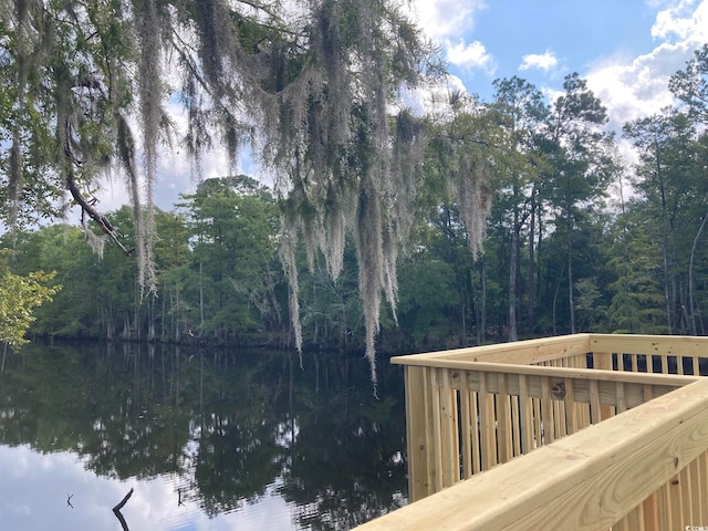 exterior space with a water view and a wooded view