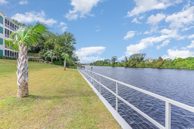 dock area featuring a water view and a lawn