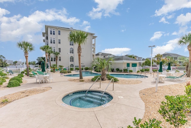 view of pool with a patio and a community hot tub