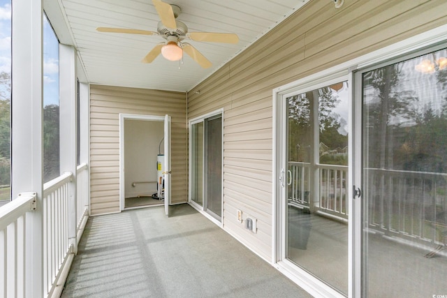 unfurnished sunroom with gas water heater, ceiling fan, and wood ceiling