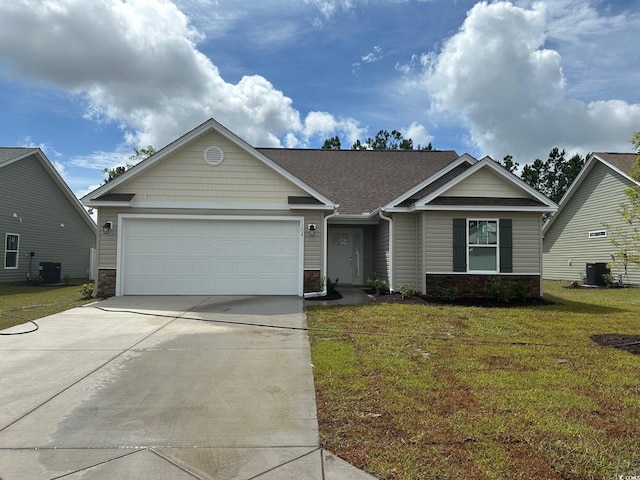 view of front of house with a front lawn, a garage, and central AC