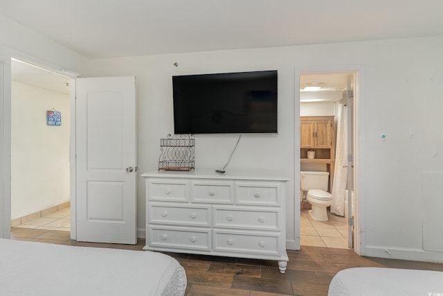 bedroom featuring dark hardwood / wood-style floors and connected bathroom