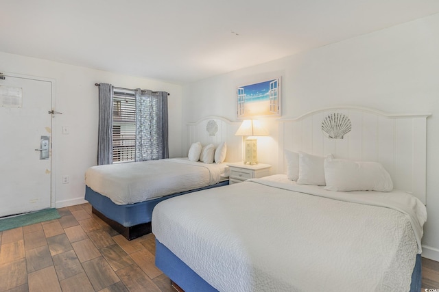 bedroom with dark hardwood / wood-style floors